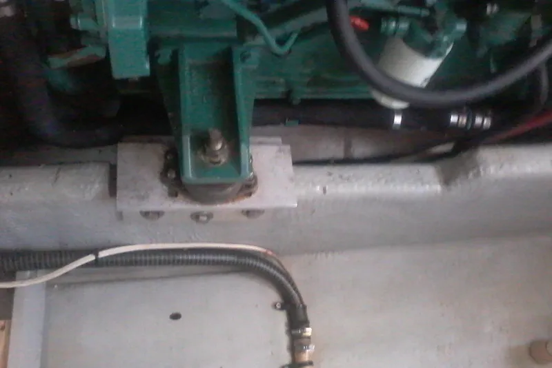 Slide: The Image of Engine compartment of a 1997 Mainship 350 boat, showing mechanical components and hoses. - 43