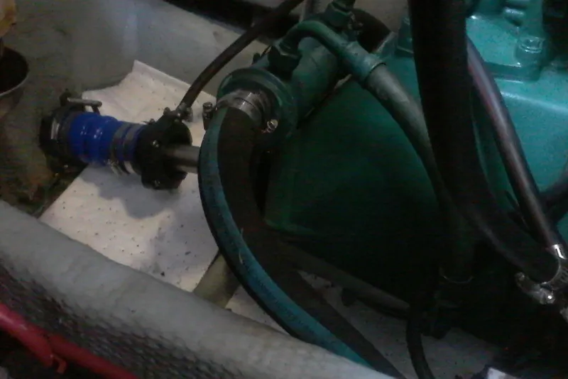 Slide: The Image of Engine compartment of a 1997 Mainship 350 boat, showing hoses and mechanical components. - 44