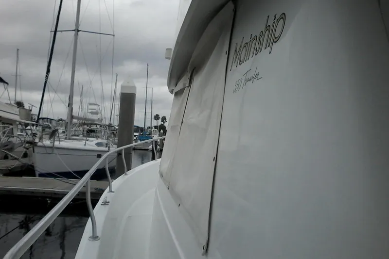 Slide: The Image of 1997 Mainship 350 yacht docked at marina under cloudy skies. - 6