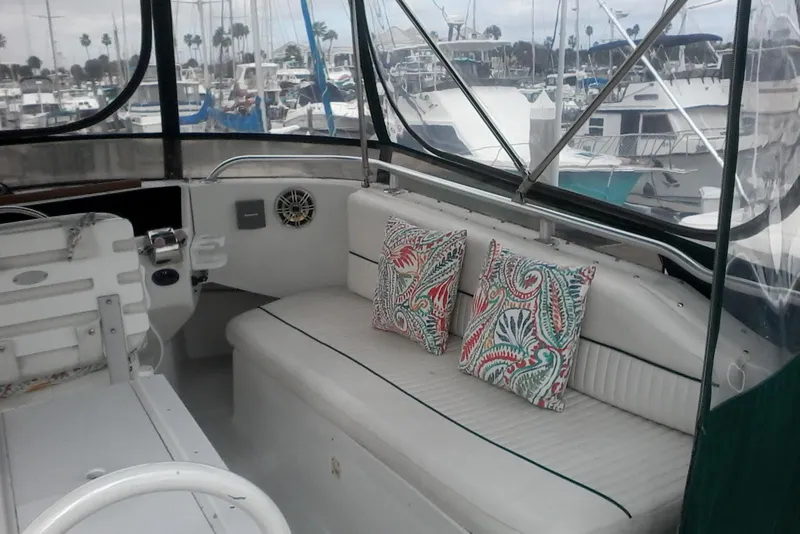 Slide: The Image of 1997 Mainship 350 boat interior with patterned cushions, docked at marina. - 7