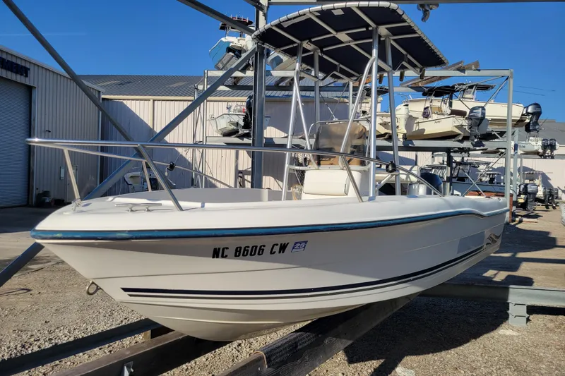 Slide: The Image of 2004 Palm Beach 1860 boat on dry dock, with T-top and visible registration number. - 4