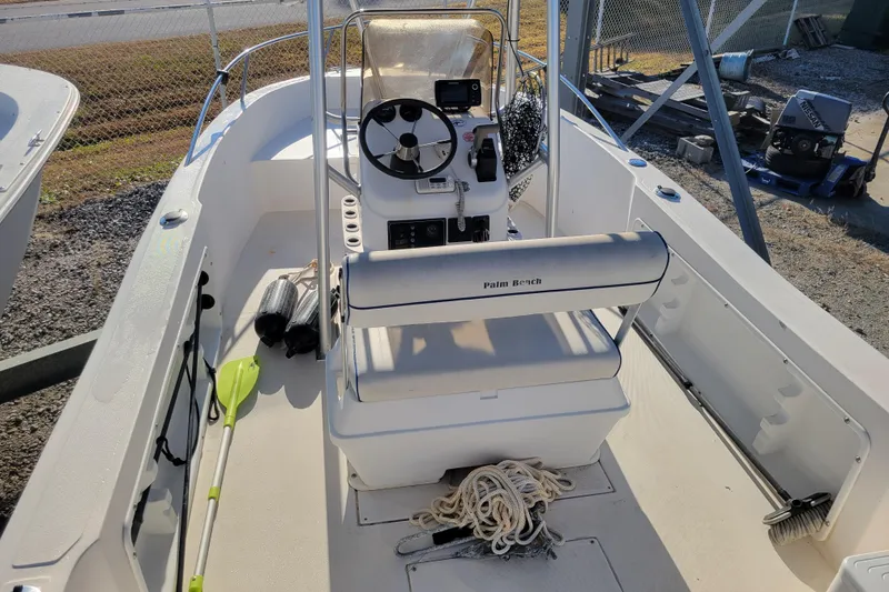 Slide: The Image of 2004 Palm Beach 1860 boat interior with steering console and accessories. - 6