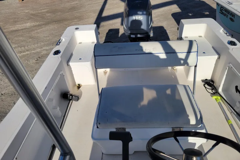 Slide: The Image of 2004 Palm Beach 1860 boat interior with steering wheel and seating. - 7