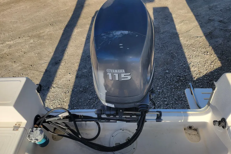 Slide: The Image of Outboard motor on 2004 Palm Beach 1860 boat, gravel background. - 8