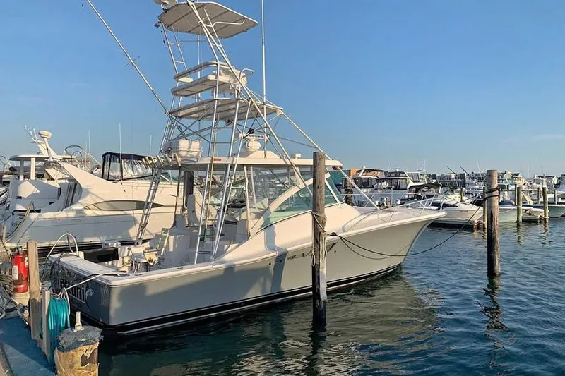 The Image of 2002 Luhrs 40 Open yacht docked at marina under clear blue sky. - 1