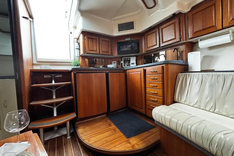Slide: The Image of Interior of 2002 Luhrs 40 Open yacht with wooden cabinetry and seating area. - 12