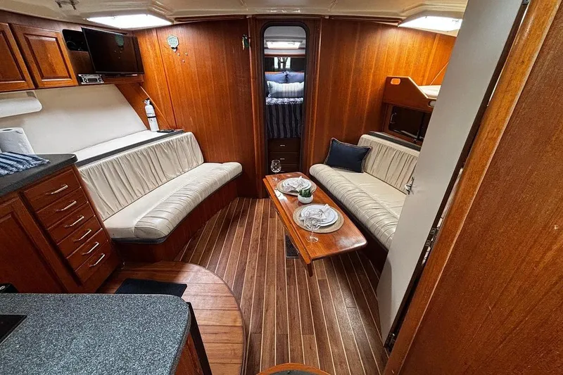 Slide: The Image of Luxurious 2002 Luhrs 40 Open yacht interior with elegant wood finish and cozy seating. - 16