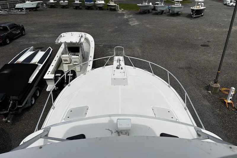 Slide: The Image of 2002 Luhrs 40 Open boat on dry dock, surrounded by other vessels. - 17