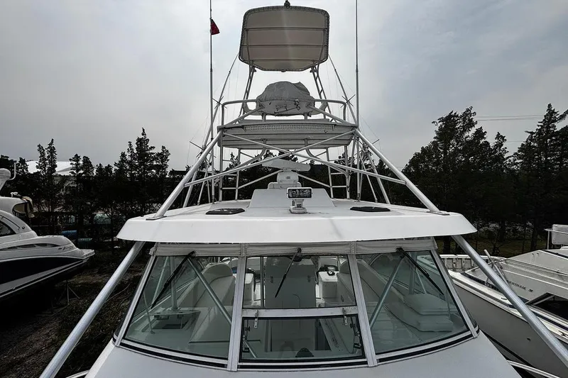 Slide: The Image of 2002 Luhrs 40 Open boat with tower, docked among trees and other vessels. - 20