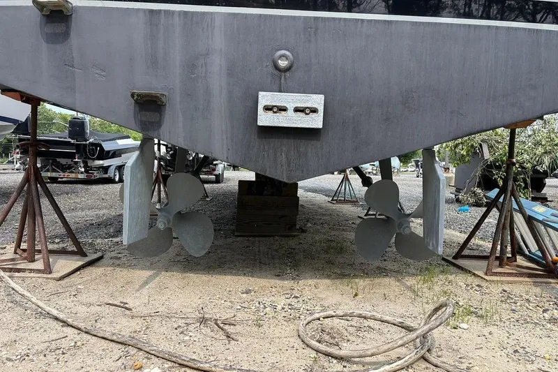 Slide: The Image of Rear view of 2002 Luhrs 40 Open boat with dual propellers on dry dock. - 28