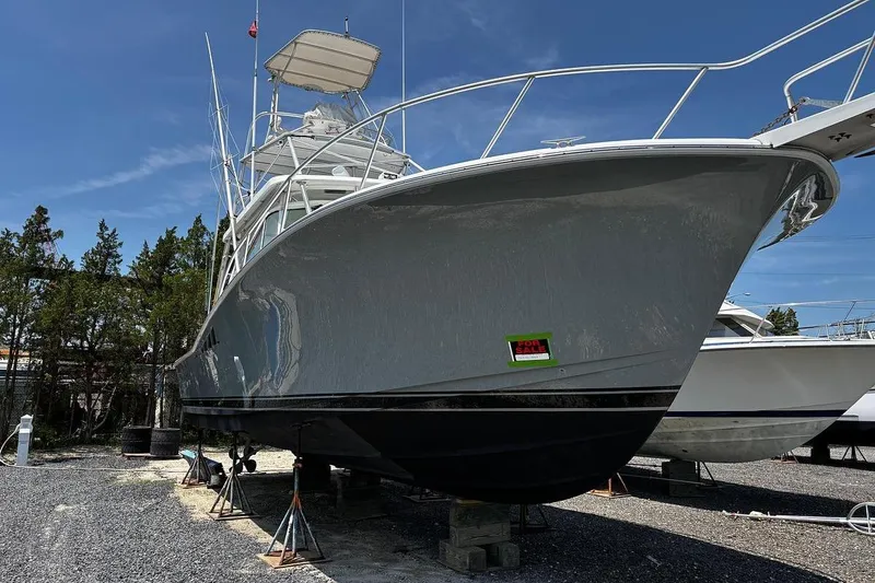 Slide: The Image of 2002 Luhrs 40 Open boat on stands, for sale, under clear blue sky. - 3