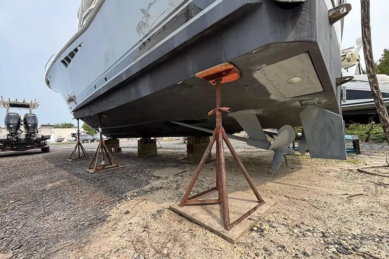 Slide: The Image of 2002 Luhrs 40 Open boat on stands, showing propeller and hull details. - 30