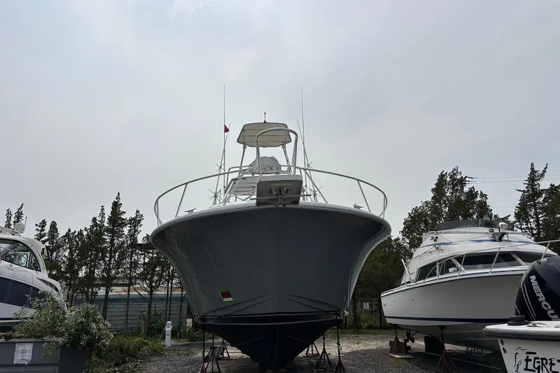 Slide: The Image of 2002 Luhrs 40 Open boat on dry dock, surrounded by other vessels. - 31