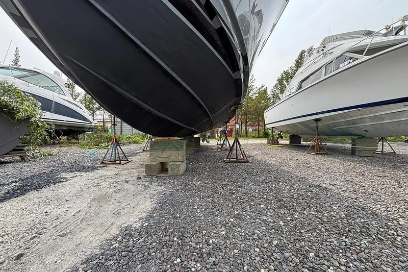 Slide: The Image of 2002 Luhrs 40 Open boat on stands, surrounded by other vessels in a boatyard. - 32
