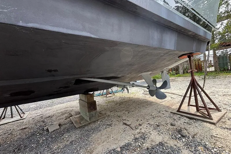 Slide: The Image of 2002 Luhrs 40 Open boat hull and propeller on dry dock. - 33