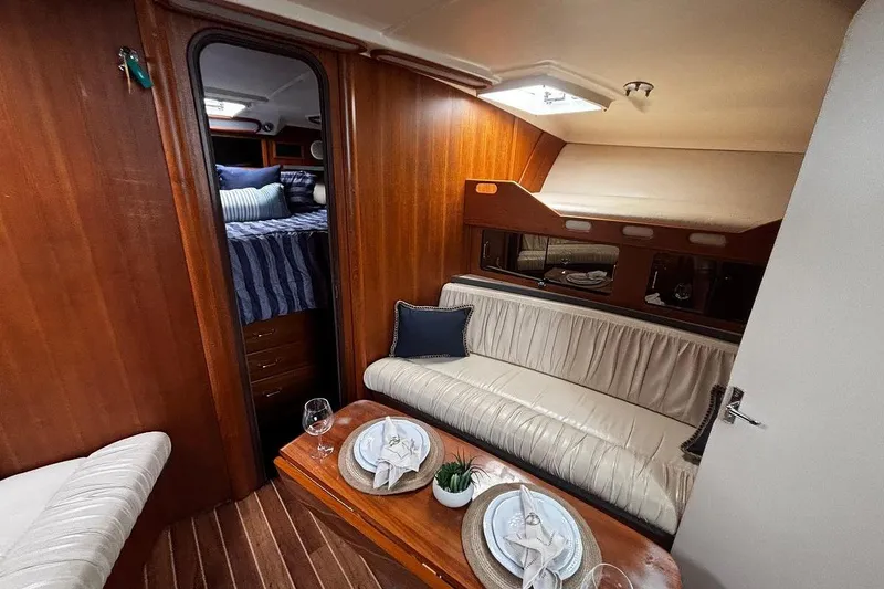 Slide: The Image of 2002 Luhrs 40 Open yacht interior with cozy seating and dining area. - 7