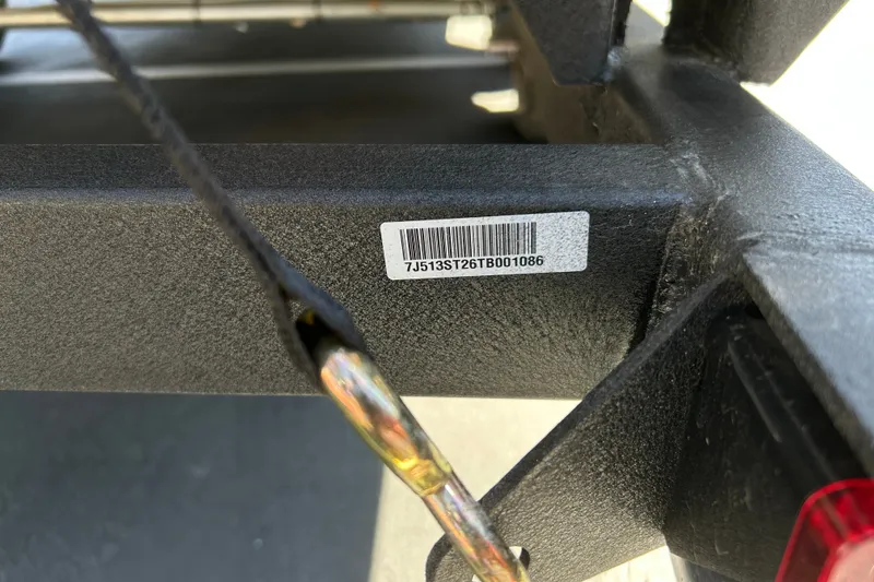 Slide: The Image of Close-up of a 2026 Sun Tracker Party Barge 24 XP3 trailer with barcode. - 92