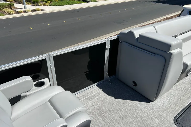 Slide: The Image of 2026 Sun Tracker Party Barge 24 XP3 interior with gray seating and cup holders. - 18