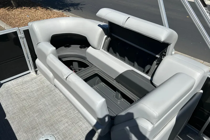 Slide: The Image of 2026 Sun Tracker Party Barge 24 XP3 interior seating with storage compartment open. - 15