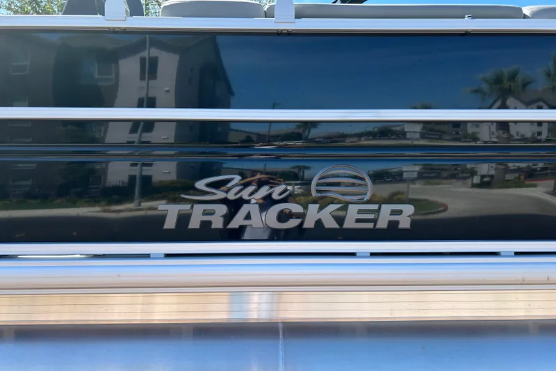 Slide: The Image of 2026 Sun Tracker Party Barge 24 XP3 logo on sleek boat exterior. - 24