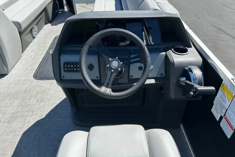 Slide: The Image of 2026 Sun Tracker Party Barge 24 XP3 steering console with modern controls and seating. - 20