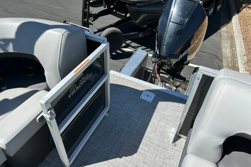 Slide: The Image of 2026 Sun Tracker Party Barge 24 XP3 with outboard motor and gray seating. - 17