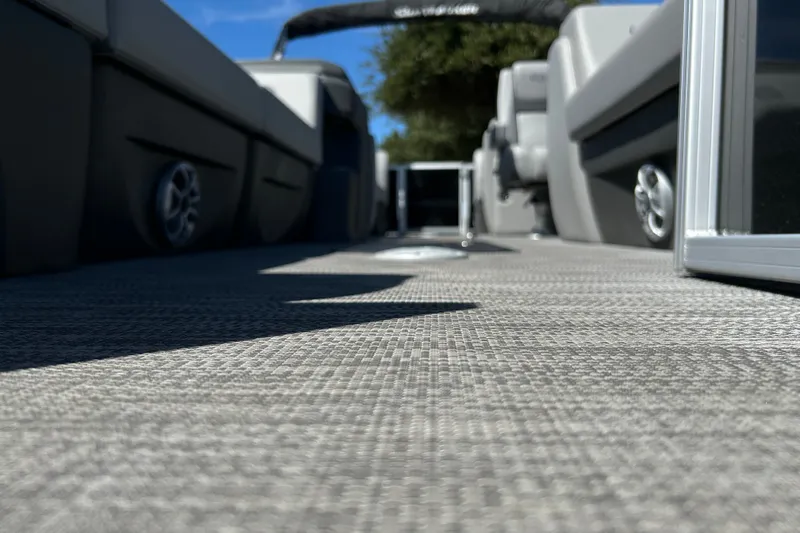 Slide: The Image of 2026 Sun Tracker Party Barge 24 XP3 interior with textured flooring and seating. - 22