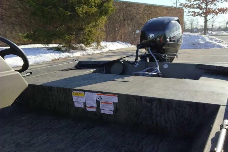 Slide: The Image of 2026 Tracker Grizzly 1648 SC boat with Mercury outboard motor in snowy setting. - 4