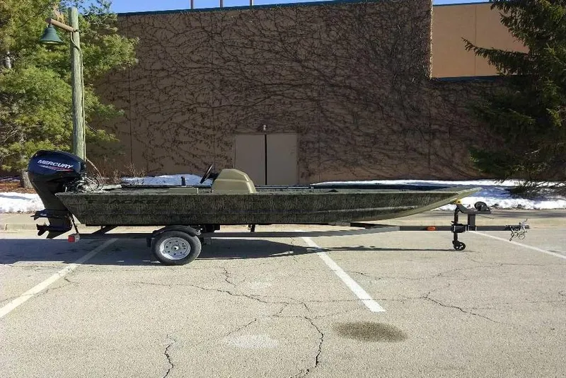 Slide: The Image of 2026 Tracker Grizzly 1648 SC boat on trailer in parking lot. - 7
