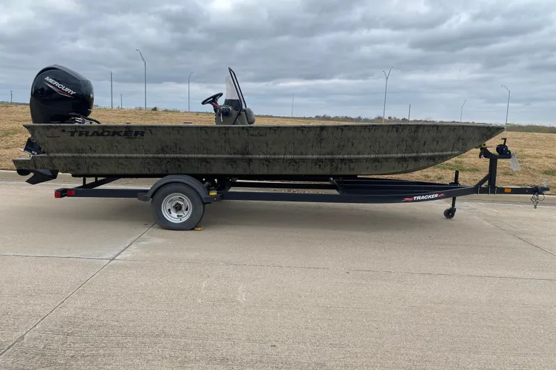 The Image of 2026 Tracker Grizzly 2072 CC boat on trailer, parked on concrete under cloudy sky. - 0