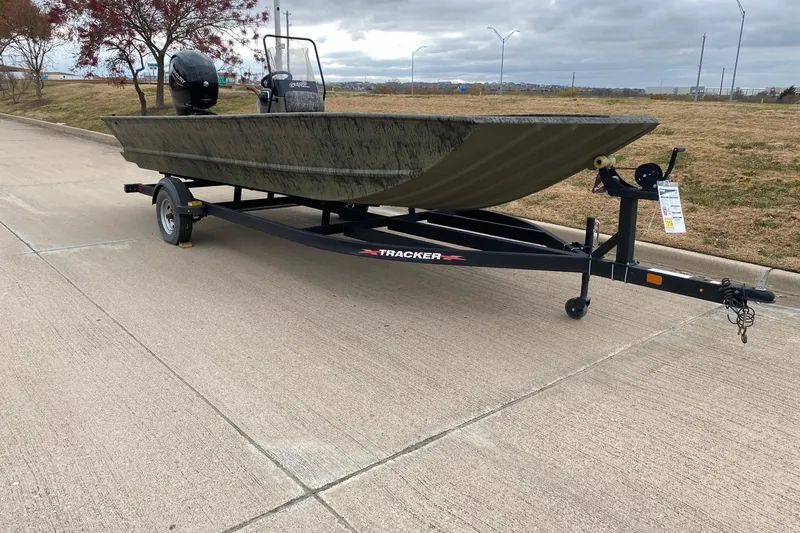 Slide: The Image of 2026 Tracker Grizzly 2072 CC boat on trailer, parked on a paved road. - 2