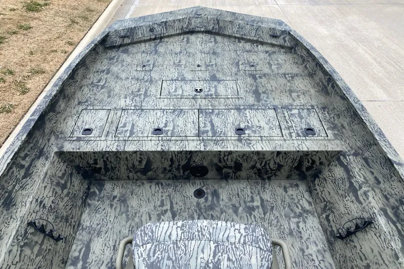 Slide: The Image of 2026 Tracker Grizzly 2072 CC boat interior with camouflage design and storage compartments. - 4