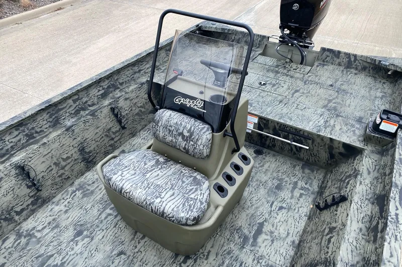 Slide: The Image of 2026 Tracker Grizzly 2072 CC boat interior with camouflage design and central console. - 5