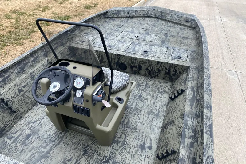 Slide: The Image of 2026 Tracker Grizzly 2072 CC boat with camouflage interior and steering console. - 7