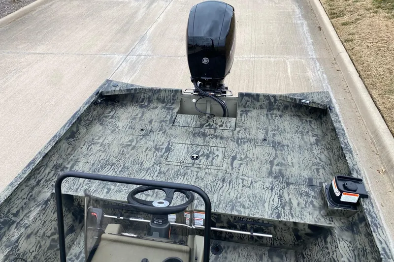 Slide: The Image of 2026 Tracker Grizzly 2072 CC boat with camouflage design and outboard motor. - 8