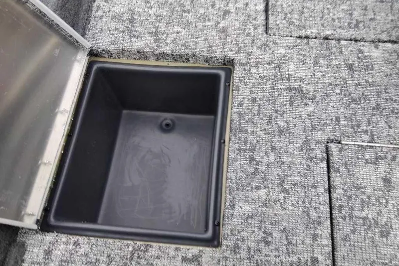 Slide: The Image of Open storage compartment on 2026 Tracker Pro Team 195 boat deck. - 59