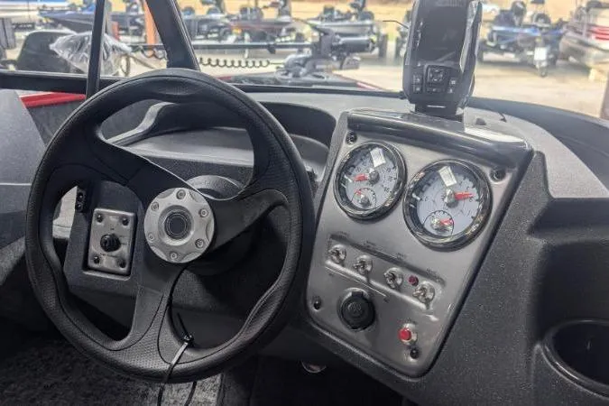 Slide: The Image of Steering console of 2026 Tracker Pro Guide V-16 WT boat with gauges and controls. - 2