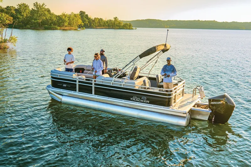 Slide: The Image of 2026 Sun Tracker SportFish 22 XP3 pontoon boat on trailer, parked on concrete. - 2
