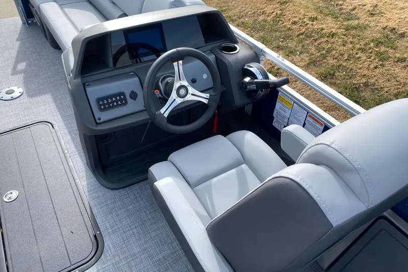 Slide: The Image of 2026 Sun Tracker SportFish 22 XP3 boat interior with steering wheel and seating. - 6