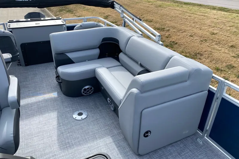 Slide: The Image of 2026 Sun Tracker SportFish 22 XP3 boat interior with gray seating and carpeted floor. - 9