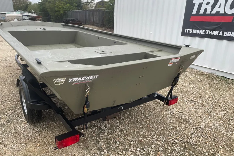 Slide: The Image of 2026 Tracker Grizzly 1754 Utility boat on trailer, parked on gravel. - 3