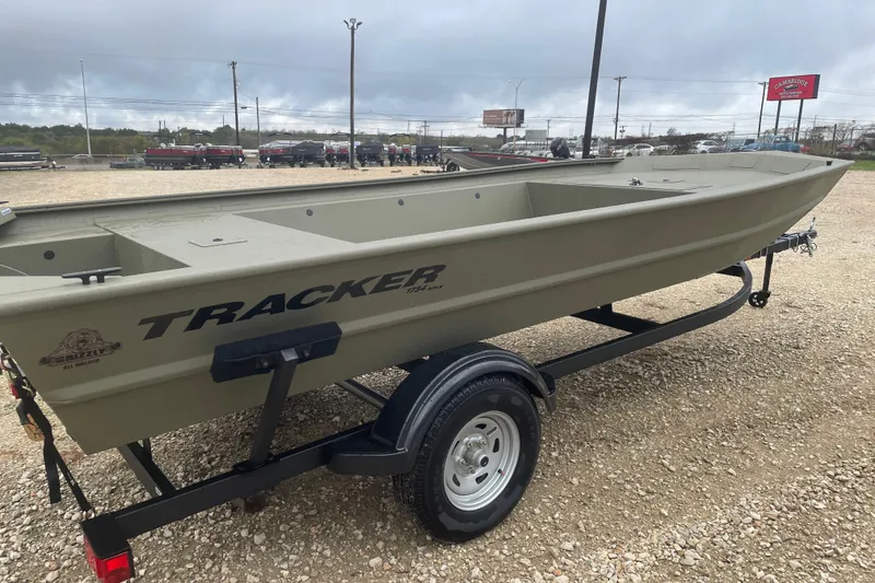 Slide: The Image of 2026 Tracker Grizzly 1754 Utility boat on trailer, displayed outdoors. - 4