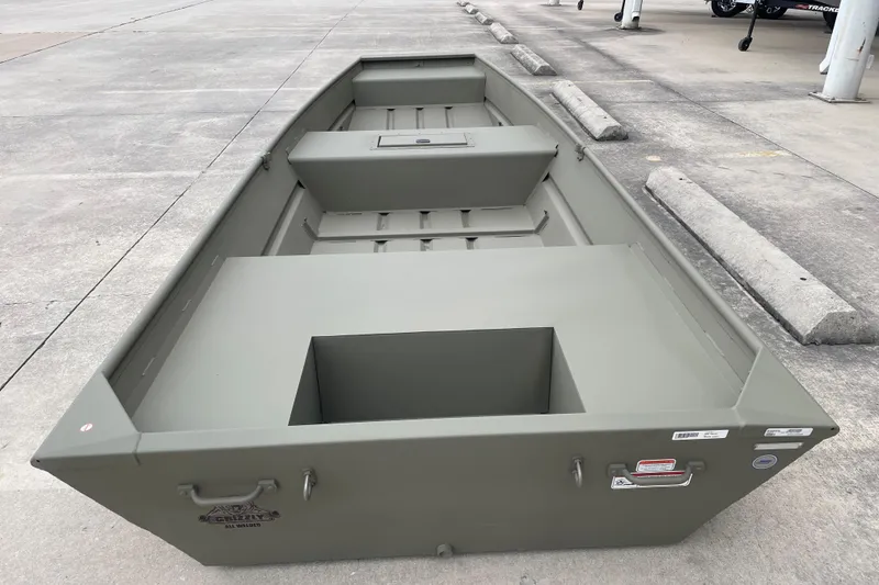 Slide: The Image of 2026 Tracker Grizzly 15 Jon boat on concrete surface, showcasing spacious interior design. - 2