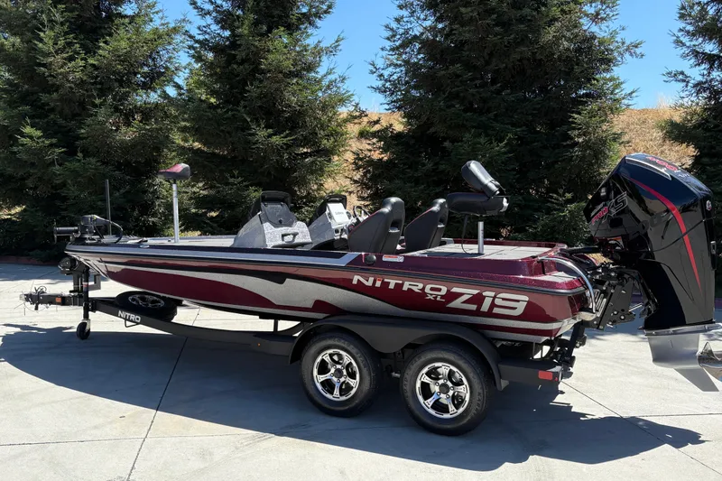 Slide: The Image of 2026 Nitro Z19 XL boat on trailer, parked outdoors with trees in background. - 4