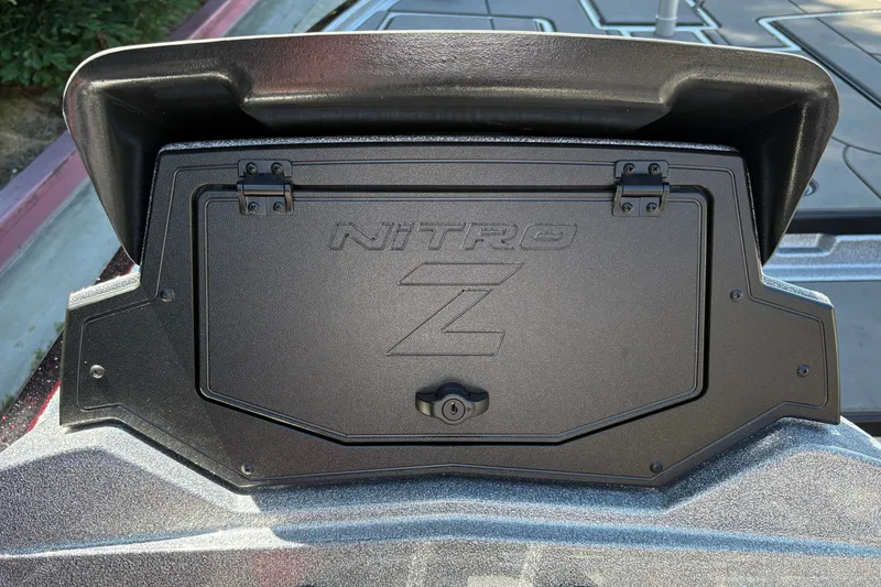 Slide: The Image of 2026 Nitro Z19 XL boat compartment with secure latch and embossed logo. - 24