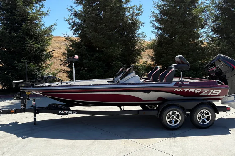 Slide: The Image of 2026 Nitro Z19 XL boat on trailer, parked outdoors with trees in background. - 1
