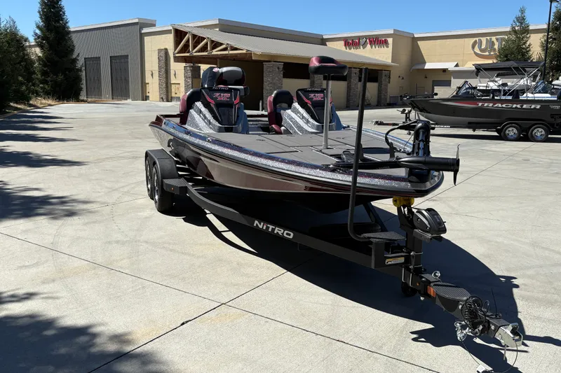 Slide: The Image of 2026 Nitro Z19 XL boat on trailer in parking lot, near Total Wine store. - 6