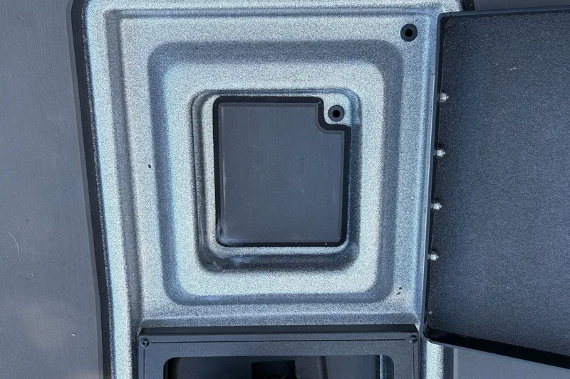 Slide: The Image of Compartment detail of 2026 Nitro Z19 XL boat, featuring textured metallic finish. - 23