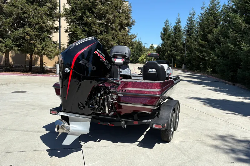 Slide: The Image of 2026 Nitro Z19 XL boat with powerful outboard motor, parked on a sunny day. - 8