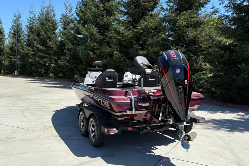Slide: The Image of 2026 Nitro Z19 XL boat with powerful outboard motor, parked outdoors. - 9
